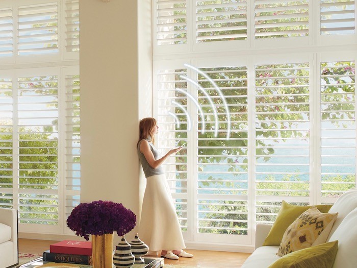 Woman using phone to operate shades